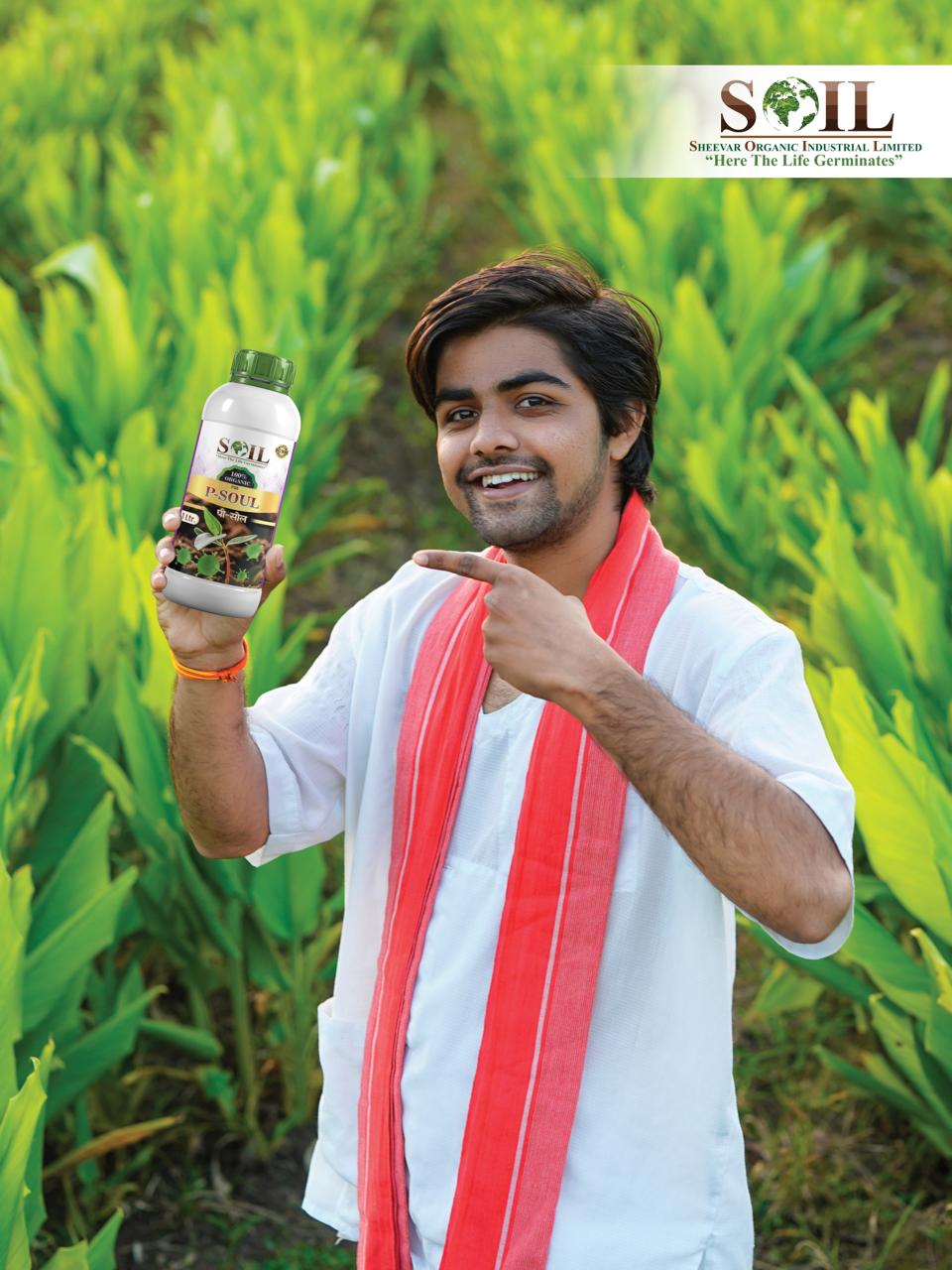 Farmer holding SOIL P-SOUL product in a crop field