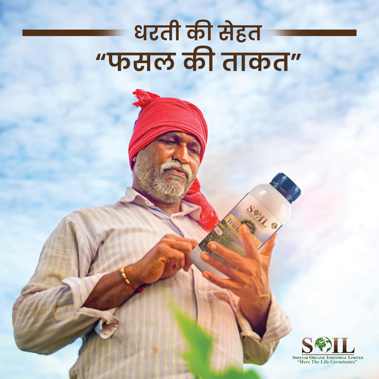 Farmer holding SOIL Trichoshield product